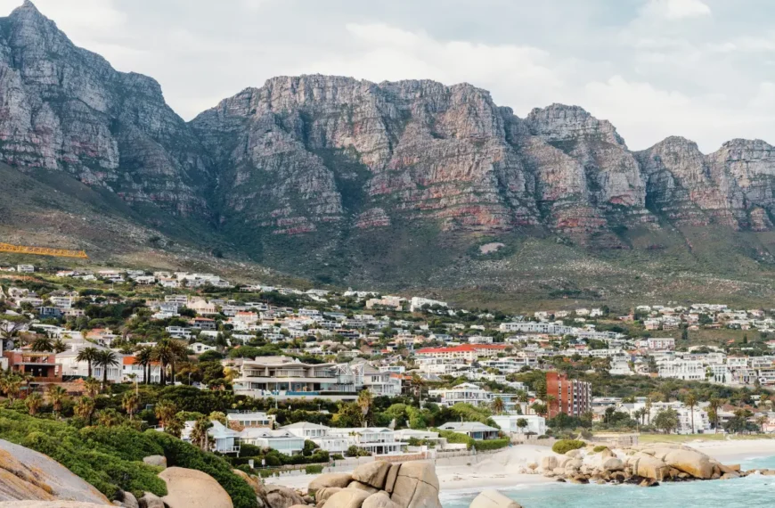 Panoramic view of Camps Bay properties below the Twelve Apostles mountains, illustrating the area affected by Cape Town height restrictions.